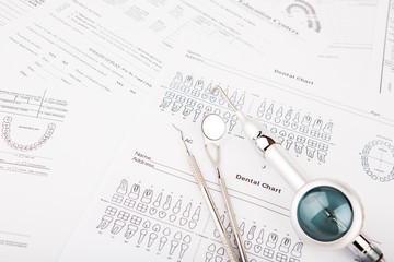Dental tools and equipment on dental chart