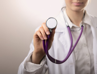 Close-up of female doctor using stethoscope