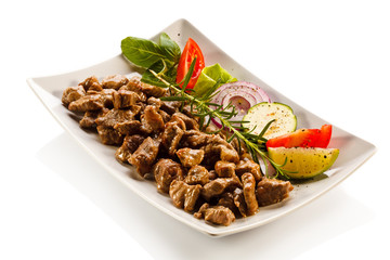 Grilled meat and vegetables on white background