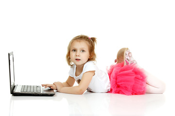 Adorable little girl using laptop