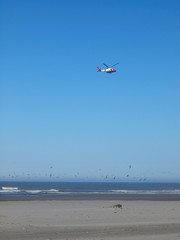 A Coast Guard Helicopter Patrolling the Shoreline on a Clear Day