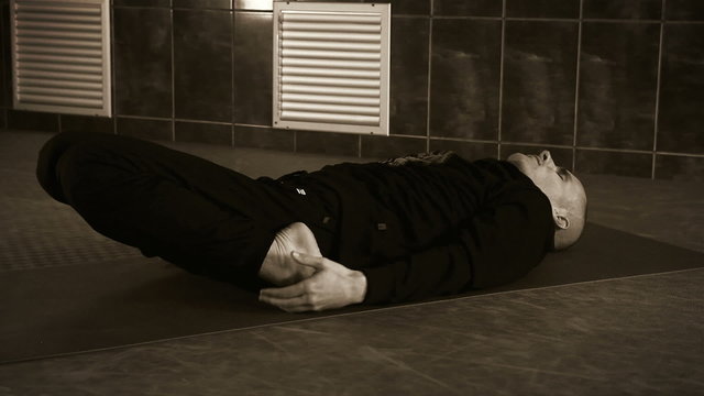 Yoga Trainer shows spine deflection exercise in the Gym