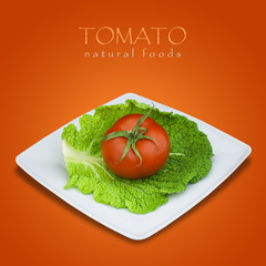 Tomato and savoy cabbage in plate on red background