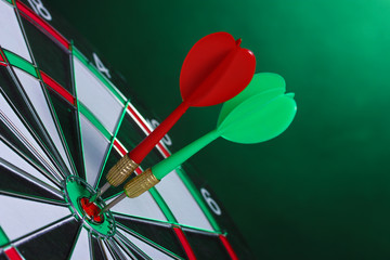 dart board with darts on green background