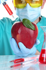 Scientist injecting GMO into the apple