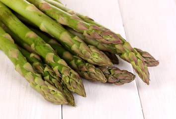 Fresh asparagus on white wooden table background