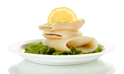 boiled squids with lettuce and lemon in the plate isolated