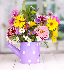 beautiful bouquet of bright flowers in watering can