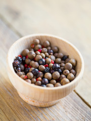 Pimento, juniper berries and pink peppercorns in a bowl