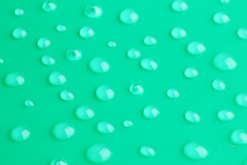 Water drops on green background