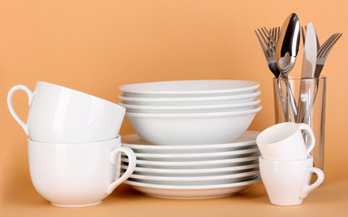 Clean white dishes on beige background