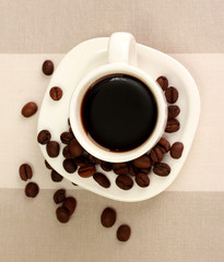 Cup of coffee on brown background