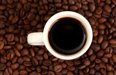 Cup of coffee on brown background