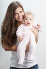 young mother  holding her baby girl on hands