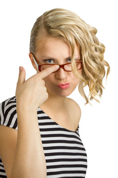 Attractive young woman adjusts glasses with finger 