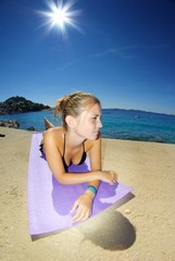 Fototapeta na wymiar Young woman, sunbathing on a beach