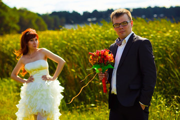 groom at the wedding holding wedding bouquet on a background of