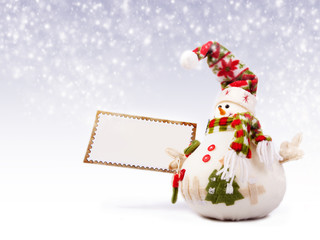 Happy snowman with greeting postcard