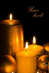 Golden Christmas Candles and spheres on the black