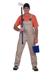 full-length portrait of painter holding tin of paint and roller