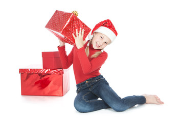 Teenage girl in santa helper hat with red gift on white
