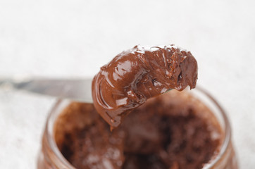chocolate paste in a glass jar close up horizontal