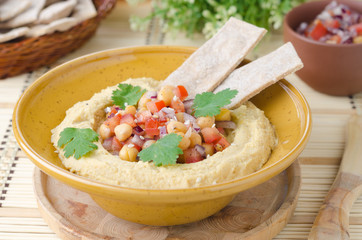 Hummus with a salad of chickpeas and tomatoes with cilantro and