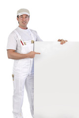 craftsman painter pointing at an ad board