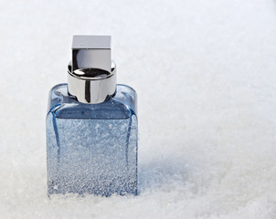 Abstract bottle of perfume, frosted, stands in the snow - 47059980
