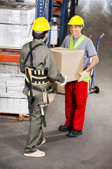 Foremen Carrying Cardboard Box At Warehouse