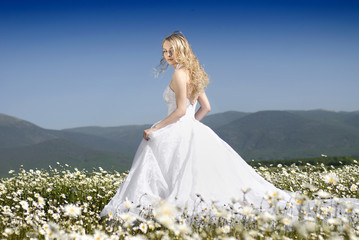 bride in daisy field