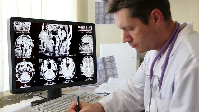Doctor in Hospital looking at CT scan