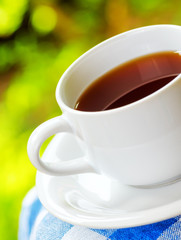 Cup of tea on nature background