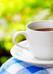 Cup of tea on nature background