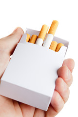 Pack of cigarettes in hand, isolated on white background