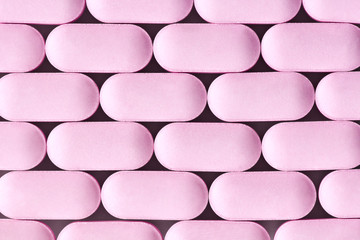 Close up of aligned pink pills