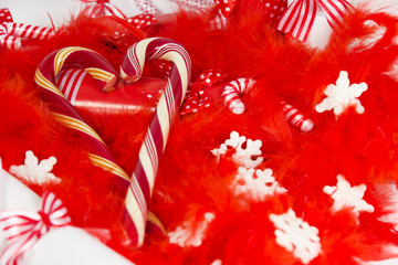 Christmas candy on a bed of red feather.
