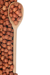 Wooden spoon with hazelnuts