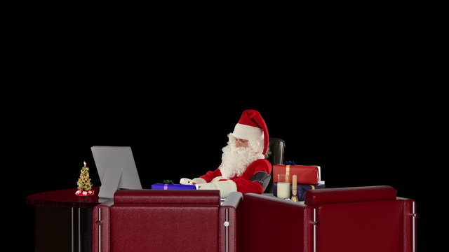 Santa Claus at work checking blood pressure, against black