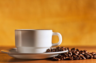 Coffee cup and saucer with coffee beans still life