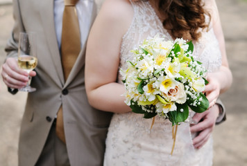 Bride holding yellow wedding bouquet