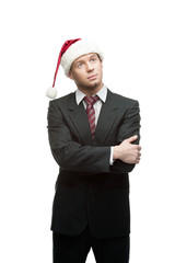 young thoughtful businessman in santa hat