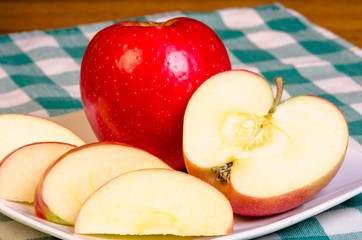 Red apple sliced on plate
