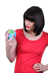 Woman holding a mini-globe