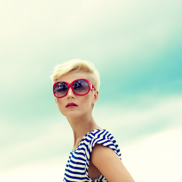 fashion portrait of a beautiful girl in the sky