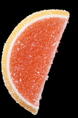 Vertical shot of a grapefruit marmalade candy, black background