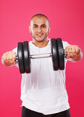 Portrait of handsome man posing on pink background