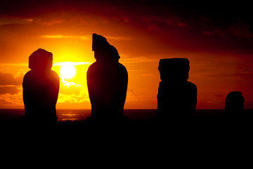 Four moai against dramatic sunset in Easter Island