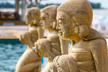 Fototapeta na wymiar Fountain statues at the tropical swimming pool in Thailand