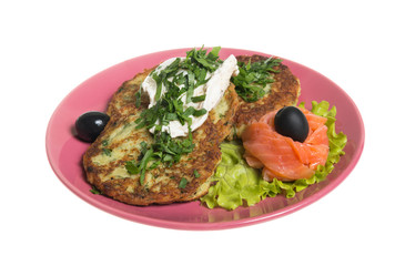 Roasted cutlets of potato with salmon on a plate